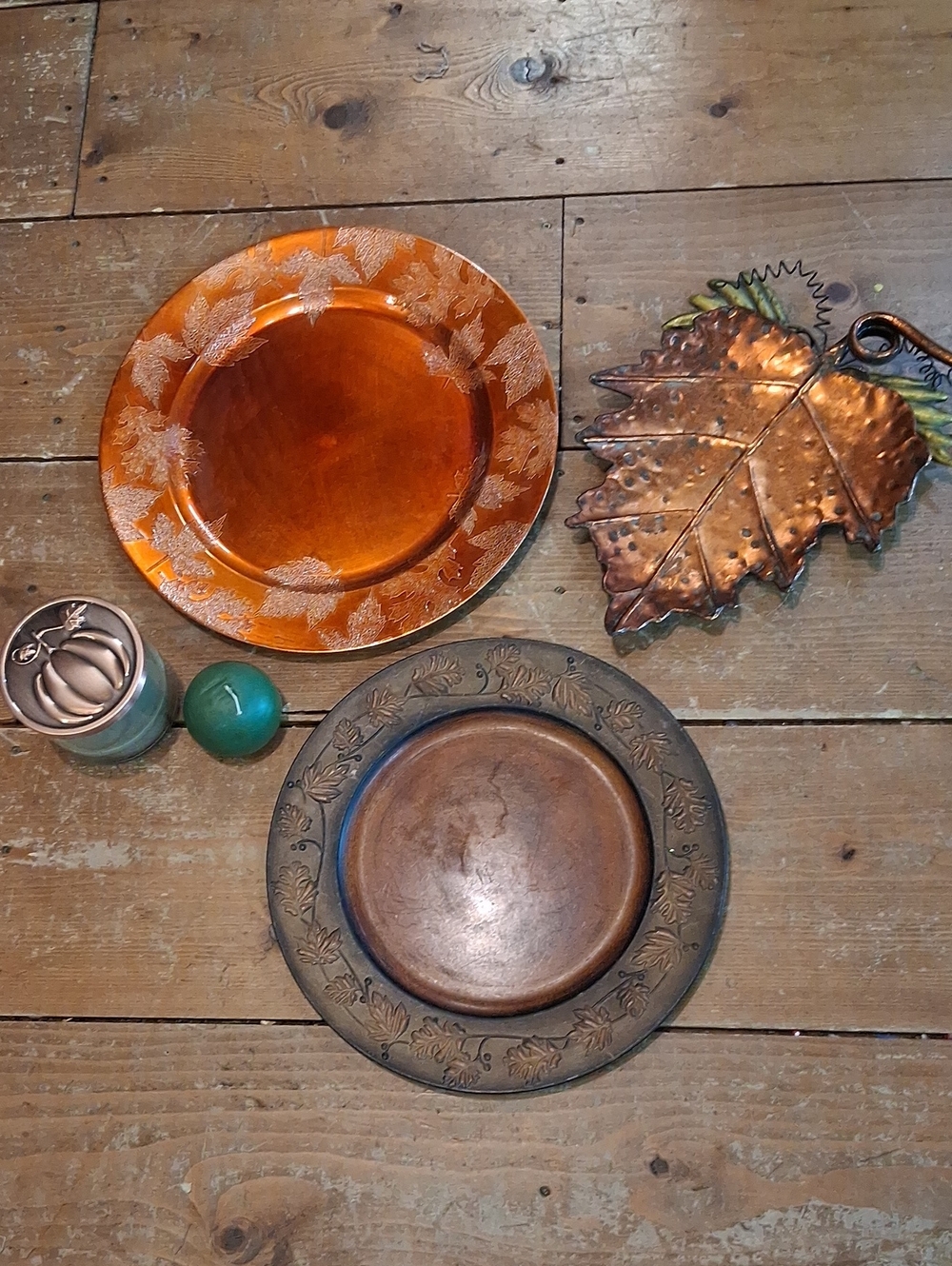 Autumn themed tableware featuring 2 chargers, a trivet, & a candle